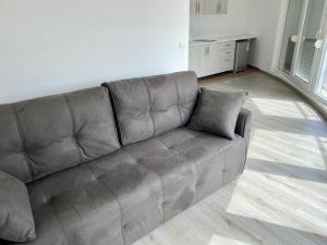 a brown leather couch in a living room at UpART House in Petrovac na Moru