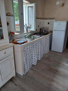 uma cozinha com um lavatório e um frigorífico em Magi - Violetta em Ponza