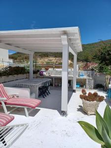 a pavilion with chairs and a table on a patio at Magi - Violetta in Ponza