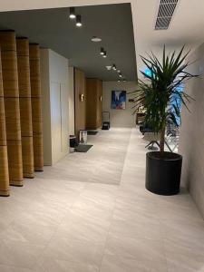 a hallway of an office with a potted plant at Havuz&Peyzaj Manzaralı LUX 2+1 in Konak