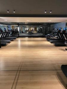 a gym with a row of treadmills and a large room at Havuz&Peyzaj Manzaralı LUX 2+1 in Konak