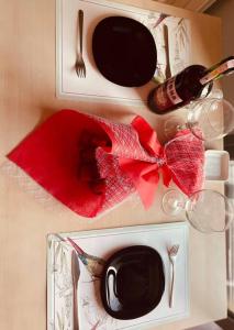 a table with wine glasses and a red napkin at Havuz&Peyzaj Manzaralı LUX 2+1 in Konak