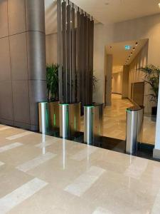 a lobby with stainless steel trash cans in a building at Havuz&Peyzaj Manzaralı LUX 2+1 in Konak