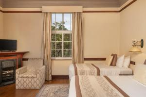 Ένα ή περισσότερα κρεβάτια σε δωμάτιο στο The Grand Hotel - Heritage Grand