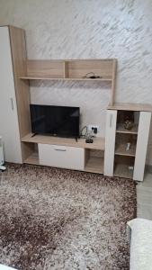 a entertainment center with a flat screen tv on a wall at Konak in Novi Pazar