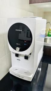 a white appliance sitting on top of a counter at Vista Alam Roomstay Homestay in Shah Alam