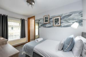 a bedroom with a bed and a window at The New Lodge in Pontardawe