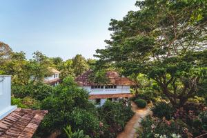 an aerial view of a house in the trees at Gaia's Garden Guest House in Auroville