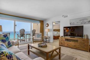a living room with a couch and a tv at Beach House 603D- Rest Ashore in Destin