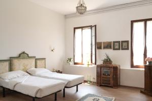 Postel nebo postele na pokoji v ubytování Fiori&vigne di Cecilia Marcon