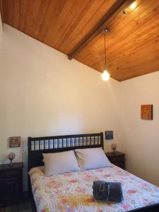 a bedroom with a bed with a purse on it at O Ninho do Rei in Vila de Rei