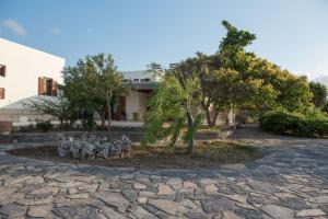 a statue of soldiers sitting on a stone road at kouremenos beach house East in Angathiás