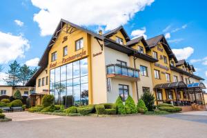 duży żółty budynek z wieloma oknami w obiekcie Hotel Szelców w mieście Lesko