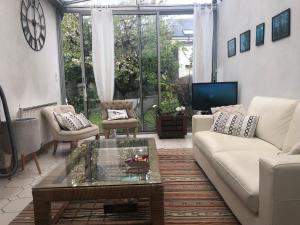 a living room with a couch and a coffee table at Maison de ville avec garage in Le Mans