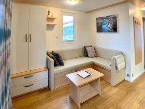a small living room with a couch and a table at BellaVista HouseBoat Apartment Portorose in Portorož