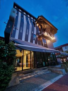 a tall building with a blue awning on it at The Peaberry Boutique Hotel in Chiang Mai
