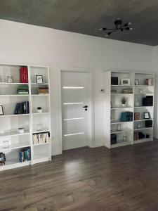 an empty room with white shelves and a door at Apartmány 400 in Veľká Lomnica