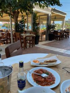 a table with a plate of food on a table at Spata Lykourgos Homes in Spata