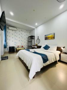 a large bedroom with a large bed and a tv at candyinn in Hue