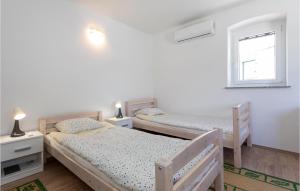 - 2 lits jumeaux dans une chambre avec fenêtre dans l'établissement Amazing Home In Opuzen With Kitchen, à Opuzen