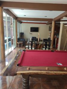 a pool table in the middle of a living room at La casita Escondida Acapulco in Acapulco