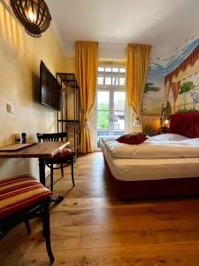 a bedroom with two beds and a table and a desk at PARK VILLA zentral am Mittelrhein Zimmer&Apartments Self check in Aparthotel in Boppard