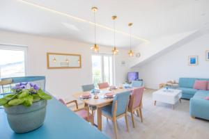 a living room with a table and a blue couch at House Duje in Plano