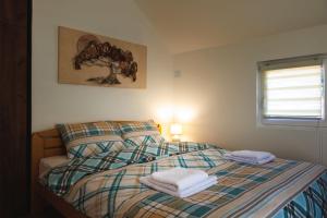 a bedroom with a bed with two towels on it at Apartmani Đorđević in Golubac