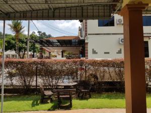 a patio with a table and chairs on the grass at Homestay Melaka Bukit Beruang in Ayer Keroh
