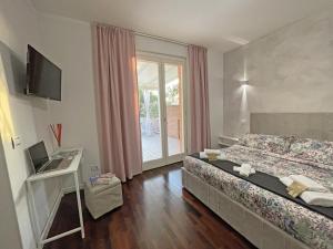 a bedroom with a bed and a desk with a laptop at B&B Belvedere in Macerata