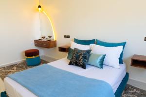 a bedroom with a blue and white bed with pillows at Imlil apartment climatisé in Azrou