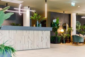 a lobby with plants and a reception desk at Amazonia Apartments in Timişoara