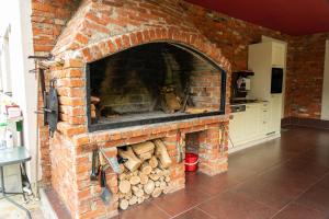 a brick oven with a pile of logs in it at Apartments MoonRiver 