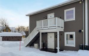 a house with a porch and a deck on it at Gorgeous Apartment In Rros With Kitchen in Røros