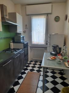 a kitchen with a checkered floor and a table in it at Siore Marie gli alloggi in San Giórgio di Nogaro