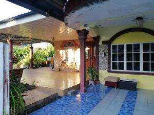 a front porch of a house with blue tiles at Love homestay CT in Kangar