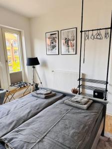 a bedroom with a large bed with two pillows on it at Schönes 3-Zimmer-Apartment in Bremen-Findorff Nähe HBF, Zentrum, Messegelände in Bremen