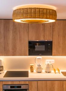 a kitchen with a chandelier above a counter at La Casa Turquesa in Águilas