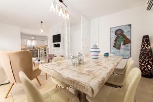 a dining room with a wooden table and chairs at Crystal Villa III in Chrissi Akti