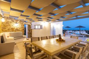 a dining room with a wooden table and chairs at Crystal Villa III in Chrissi Akti