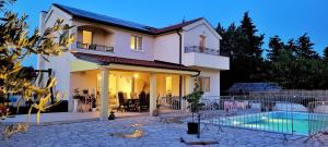 a house with a swimming pool in front of it at Villa Valentina Nin in Ninski Stanovi
