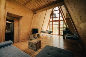 a living room with a large window in a wooden house at Ábrahám Cabin House in Ábrahámhegy