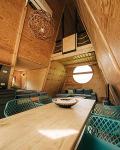 a dining room with a wooden table and chairs at Ábrahám Cabin House in Ábrahámhegy +14 photos