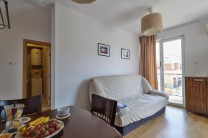 a living room with a table and a couch at Messembria Resort in Sunny Beach