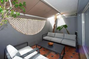 a living room with a couch and a table at Beautiful and Quiet Family Townhouse in Great Location in Marbella
