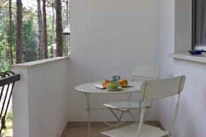 a small table and chair in a room with a window at Villa Antonietta 3, tra pineta e mare in Bibione