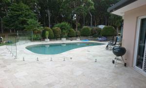 a swimming pool with a grill next to a house at Amberlyn Escapes in Killcare