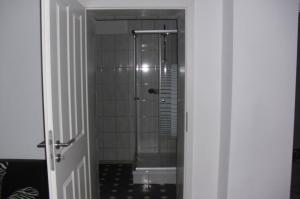 a shower with a glass door in a bathroom at gramelower see in Teschendorf
