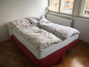 a bed with a quilt on it in a bedroom at Sarajevo, Lovely two bedroom apartment in the very center in Sarajevo