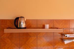 a tea kettle sitting on a shelf in a kitchen at Apartments MoonRiver 